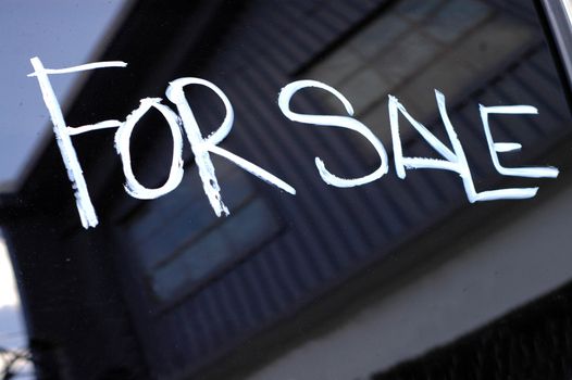 Recession Image of For Sale Sign Near a Boarded Up, Abandoned Industrial Building