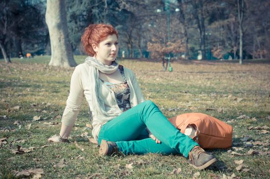 red long hair girl at the park in spring 