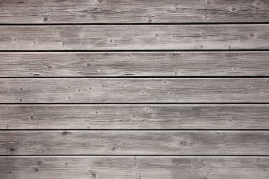 weathered grey boards of fencing or boarding