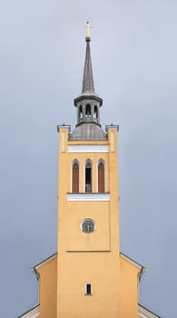 tower with a clock on the background of blue sky