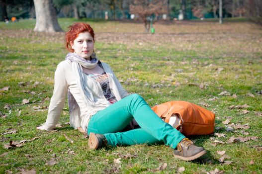 red long hair girl at the park in spring 