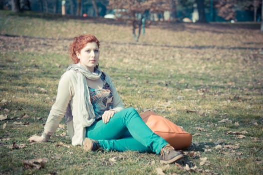 red long hair girl at the park in spring 