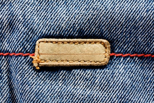 Blue jeans cloth with leather label, texture