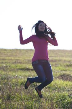 beautiful teenager  woman jumping outdoors