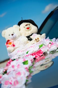 small teddy plush on a wedding. Decorate on the car.