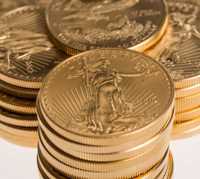 Stacks of gold eagle one troy ounce golden coins from US Treasury mint