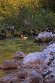 KOBARID, SLOVENIA - AUGUST 19: An sport kayaker rowing in the Soca river, August 19, 2012 in Kobarid, Slovenia