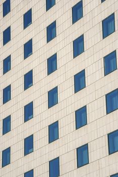 Modern public building wall,  blue windows as background