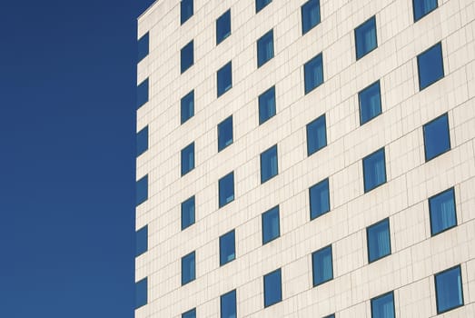 Modern public building wall,  blue windows as background