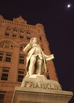 Benjamin Franklin Statue Old Post Office Building Pennsylvania Ave Washington DC with moon in the background