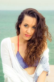 Portrait of a beautiful brunette woman at the beach