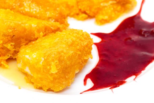 Fried Cheese with Berry Sauce on plate, closeup 