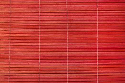 Red reed mat texture closeup as background