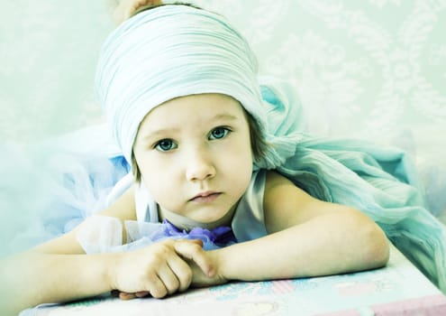 girl is lying on the big book, pure magic, pure neauty, beautiful little girl portrait