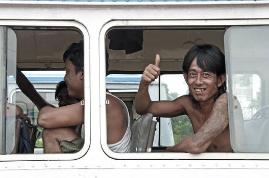 man smiling on yangon myanmar bus burma