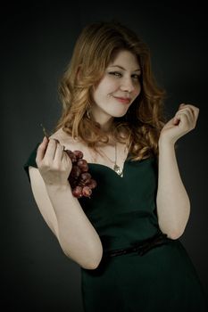 Beutiful young woman  with red hairs in green dress.