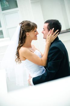 groom and bride embrace. look against each other. tenderness feeling