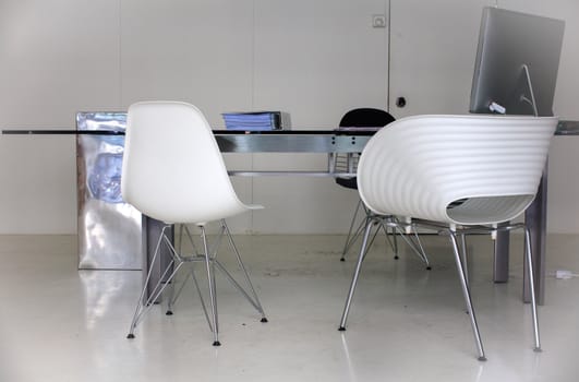 View of desk and chairs in a white office