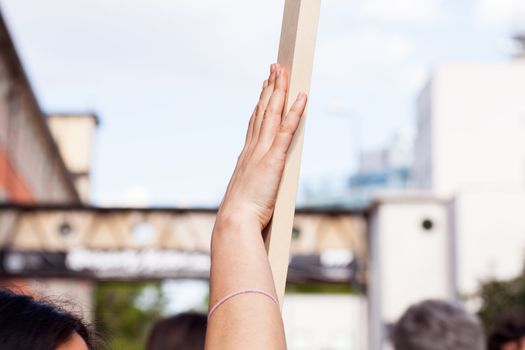 Girl with Wooden pole held by hand