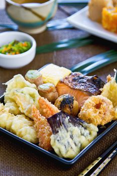 Japanese Bento set contain varieties of vegetables and fish in batter with Nori maki