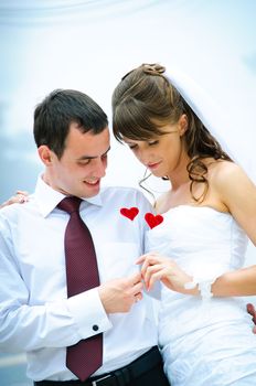 wedding couple looking on red decorative heart