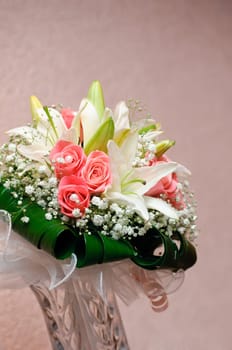 New wedding bouquet with rose and lily standing in vase