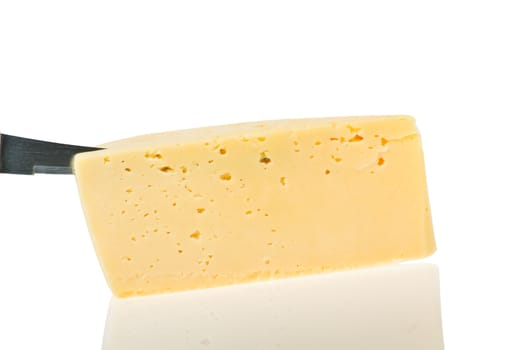 cheese piece with knife is reflected in a white background