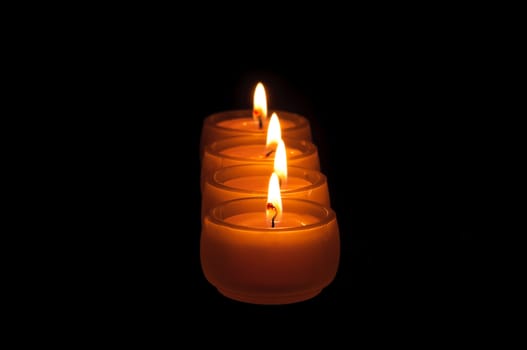 Beautiful candles burning on a black background