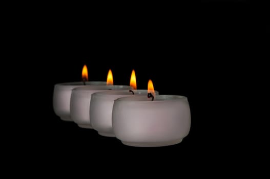 Beautiful candles burning on a black background