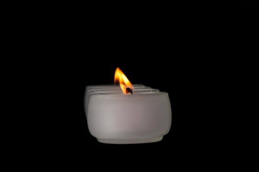 Beautiful candles burning on a black background