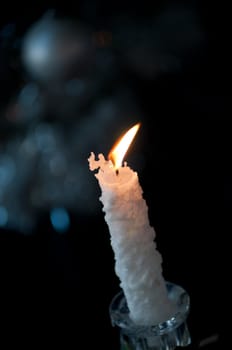 Burning candle on a blur background