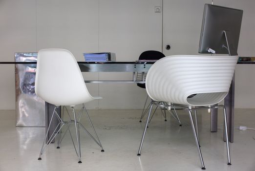 View of desk and chairs in a white office