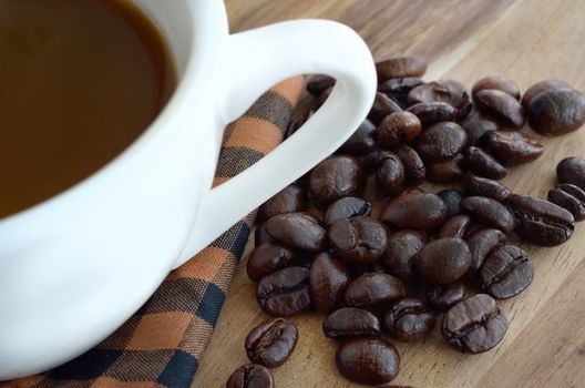 Coffee cup and beans  on wooden