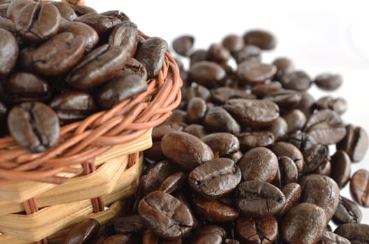 Coffee beans and basket  isolated on white
