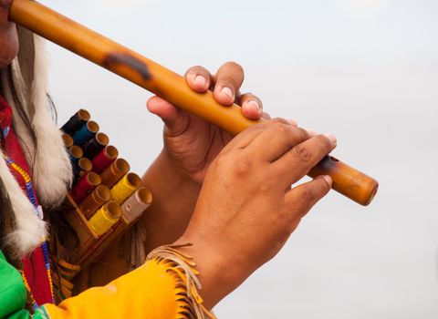 Peruvian Man In Native Costume Playing flute