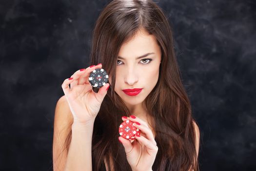 Pretty long hair woman holding chips for gambling