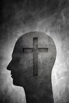 Conceptual image of a head with a christian cross symbol.