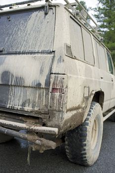 Old very dirty off-road car with mud and dirt.