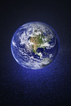 A Glowing earth on asphalt road. Earth image provided by NASA.