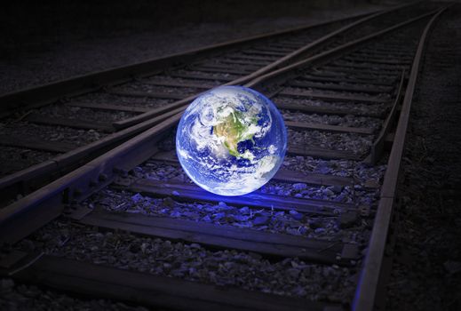 Glowing earth on an old railroad track. Earth image provided by NASA.