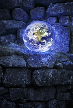 Planet earth on an old castle wall. Earth image provided by NASA.
