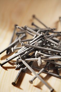 A Heap of nails on wood.
