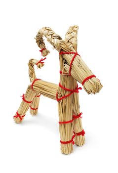 Traditional Finnish christmas decoration straw billy goat made of straws and red yarn.