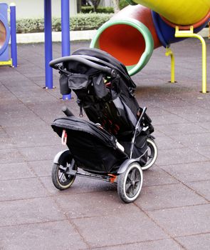 Single baby carriage in playground