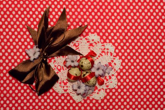 Easter eggs with red ribbon  and  white napkin  on red 