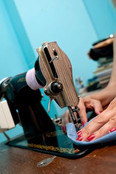 close-up hands and old sewing machine. working process