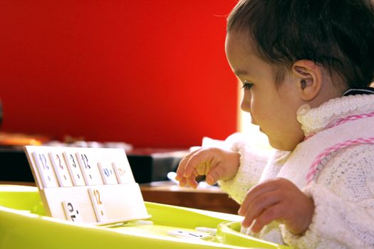 Baby boy one year old playing rummy