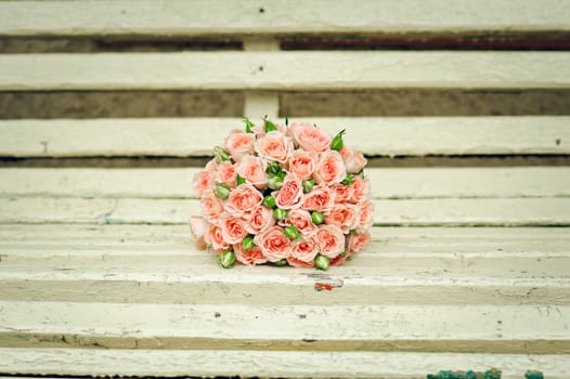  beautiful bouquet of roses lie on a bench