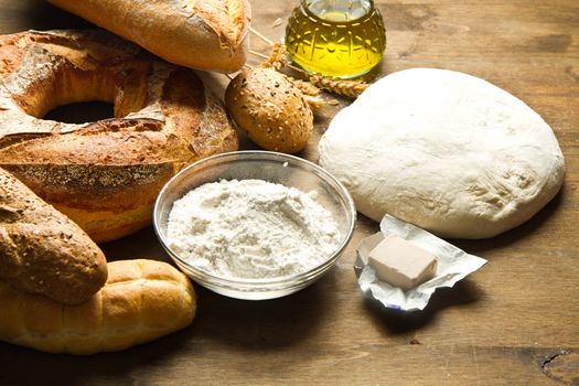 ingredients for homemade bread on wooden background