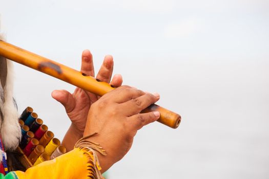 Peruvian Man In Native Costume Playing flute